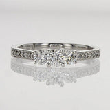 round 3 stone ring with round diamonds set on the shoulders of the ring - Engagement Rings